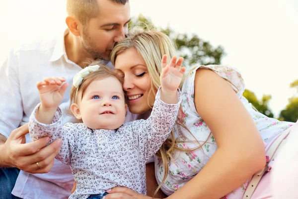 Familia feliz en un parque en verano . — Foto de Stock