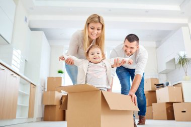 A happy family moves to a new apartment.  clipart
