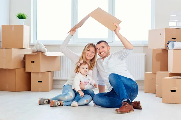 Uma família feliz muda-se para um novo apartamento . — Fotografia de Stock