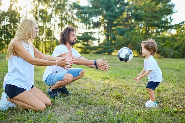 Familie spielt mit Ball im Park. — Stockfoto