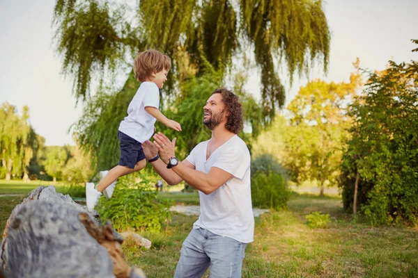 Padre jugando con su hijo en el parque. — Foto de Stock