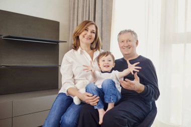 Büyükanne ve büyükbaba önünde bir odada torunu ile 