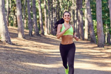 Bir kız açık havada ormanda koşu. 