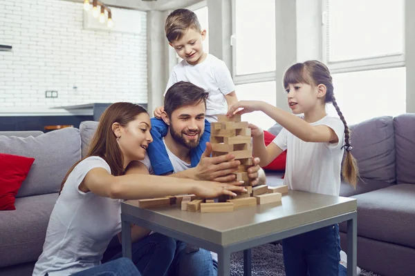 Happy family playing board games at home.