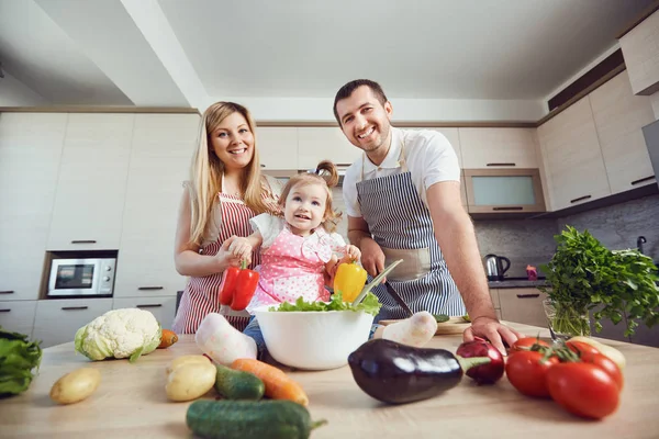 A happy family prepares food  in the kitchen. — Stock Photo, Image