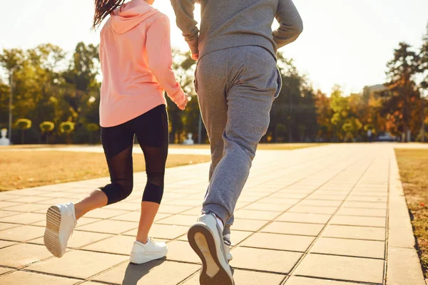 Tillbaka visa sportiga par kör längs stadens gata på morgonen. — Stockfoto