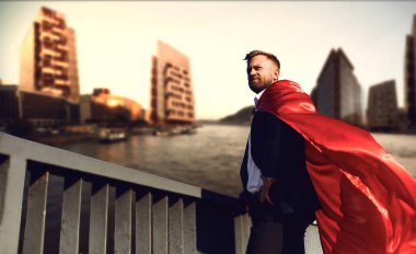 Successful superhero businessman on a business building background clipart