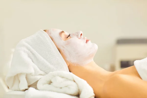 White mask on the face of a young woman — Stock Photo, Image