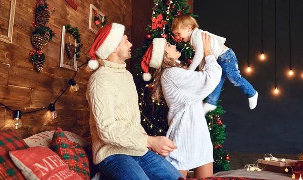 Mutter und Vater werfen Weihnachten ins Haus — Stockfoto