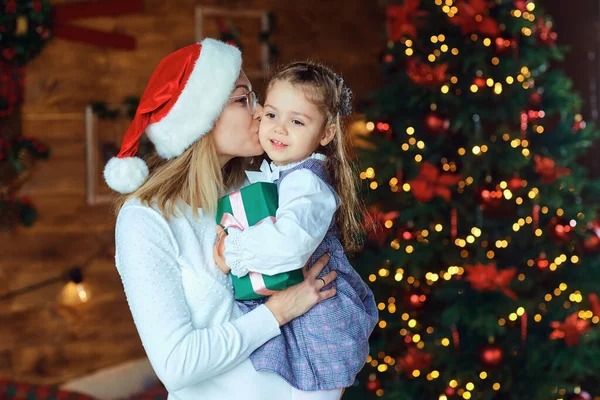 Mom with her daughter with gifts at Christmas. — Stock Photo, Image