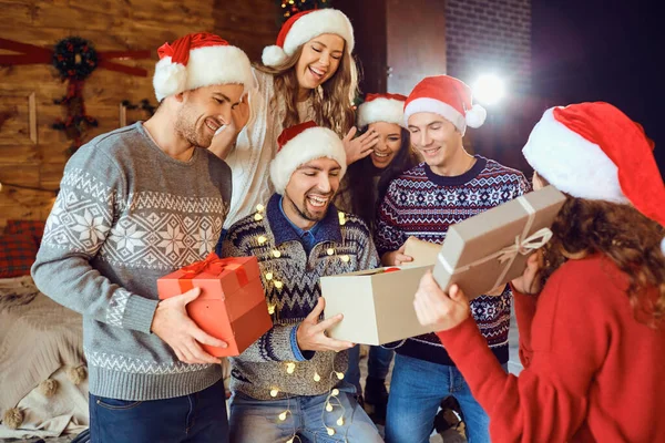 Friends with gifts celebrating Christmas. — Stock Photo, Image