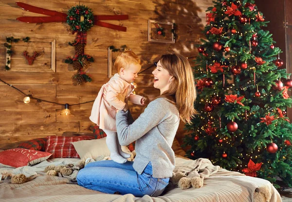 Moeder met de baby in de kamer in Kerstmis. — Stockfoto
