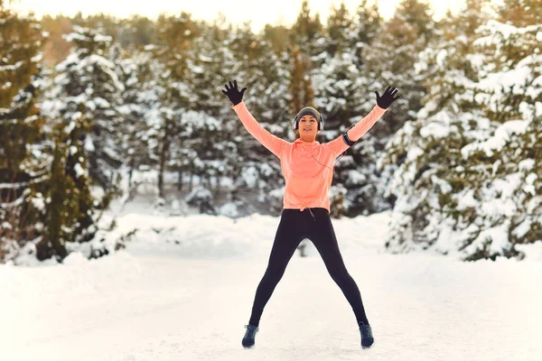 Woman does a warm-up in the snow in winter. — Stock Photo, Image