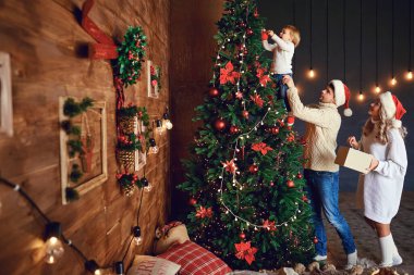 Aile süslemesi Noel ağacını birlikte sevmek