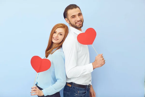 Cheerful couple with paper hearts — Stock Photo, Image