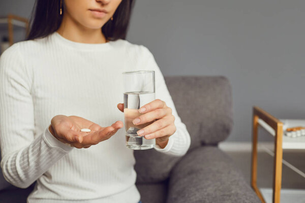 Pills tablet in hand of the girl in the room. Concept virus cold pill sick flu sickness headache flu illness