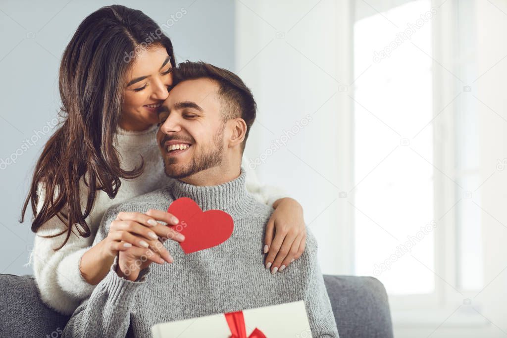 Valentines day. Couple gives heart to the Valentines Day in the room.