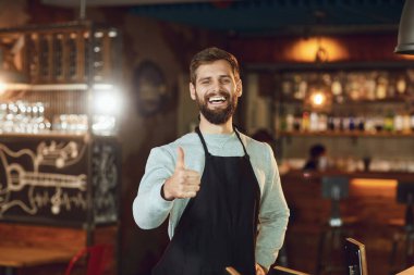 Sakallı barmen garson parmağını bir restoran barına kaldırdı..