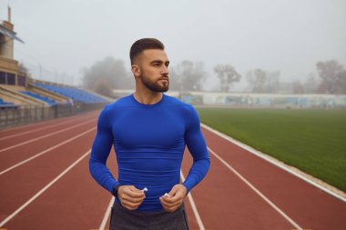 Sisin içinde sabah stadyumda duran sakallı sporcu çocuk..
