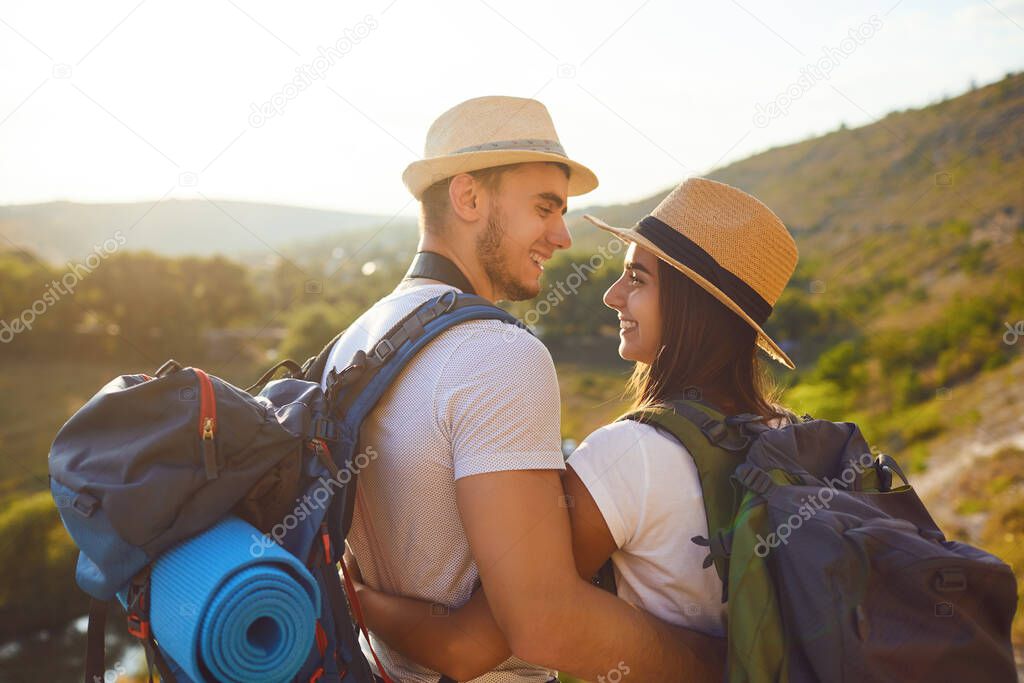 Romantic couple hikkers with backpacks on hikking the nature.