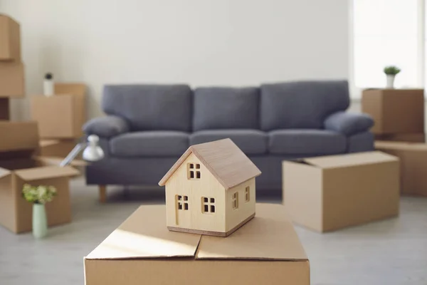 Model of the house on the floor in the new bright sunny house.