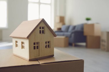 Model of the house on the floor in the new bright sunny house.