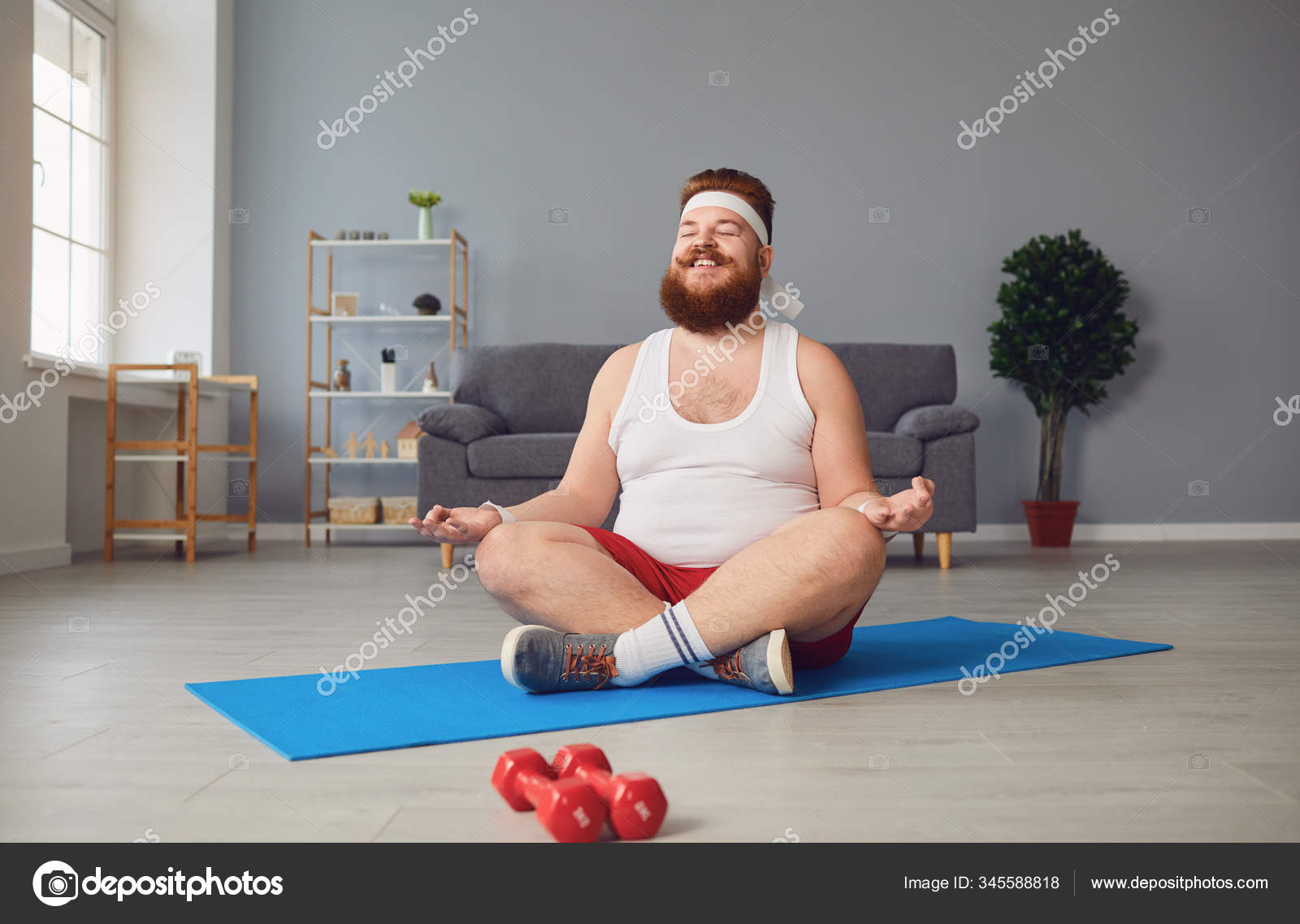 Funny yoga. Fat man doing yoga exercises in the room. Stock Photo