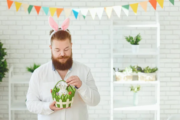 Happy easter. Funny male bearded man smiling on easter background