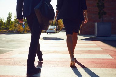Geri görünüm. İş Adamları şehir caddesi boyunca yürüyor.