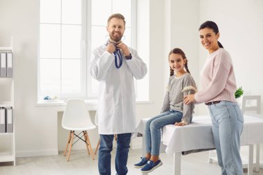 Woman with daughter visiting doctor in hospital