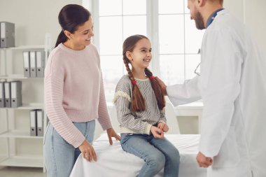 Family mom and daughter visiting a pediatrician at the clinic.