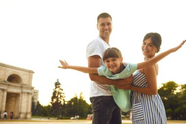 Mutlu gülümseyen aile sokakta yürüyüş.