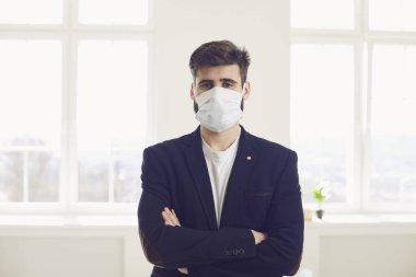 Virüs koronavirüs enfeksiyonu tehlikesi. Ofiste maskeli bir iş adamı var.