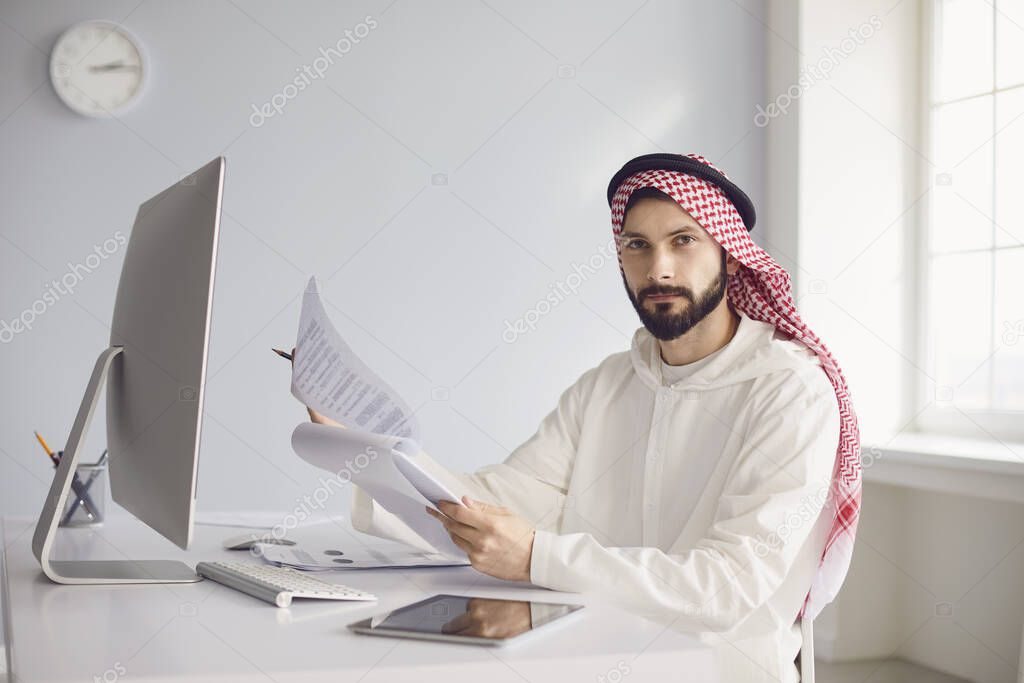 Arab businessman worker works in computer on the workplace in the office.