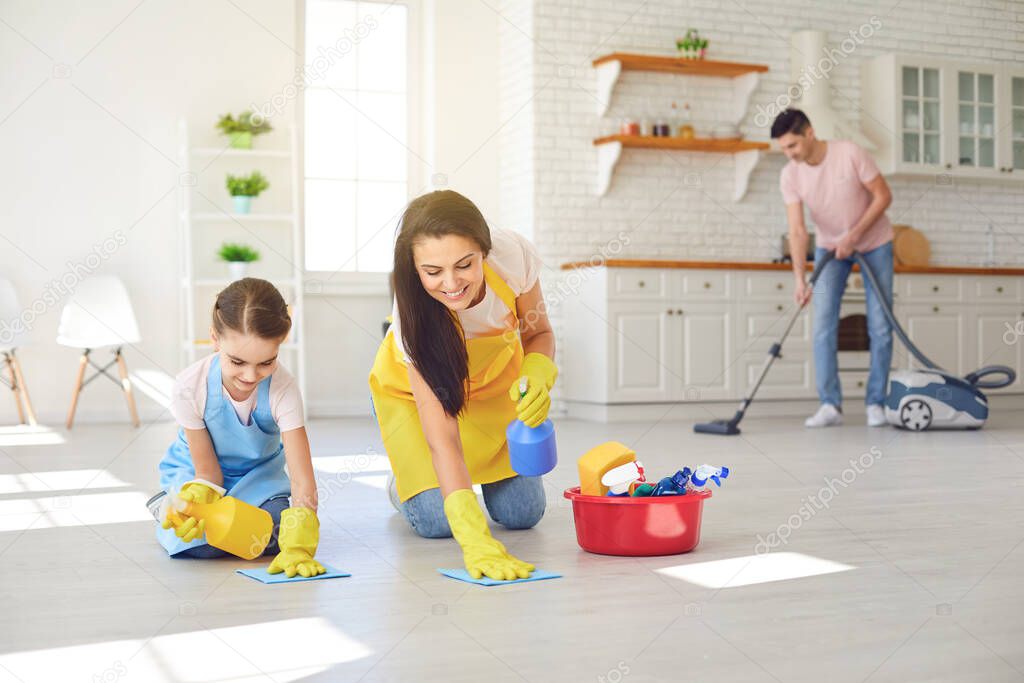 Happy family cleans the room in the house.