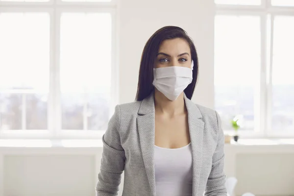 Danger of infection of the virus coronavirus infection. Businesswoman in medical mask at office — Stock Photo, Image
