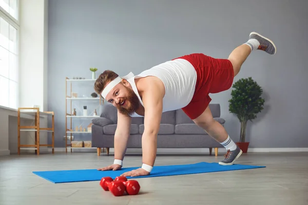 Funny fat man doing yoga exercises in the room. — 스톡 사진
