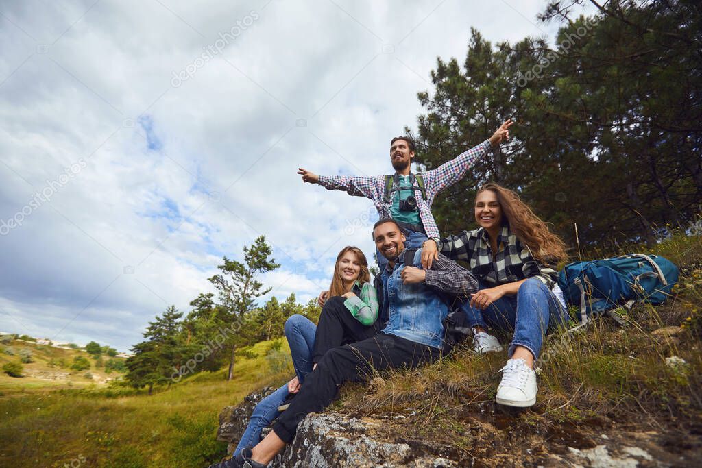 A group of tourists resting while sitting in a forest.