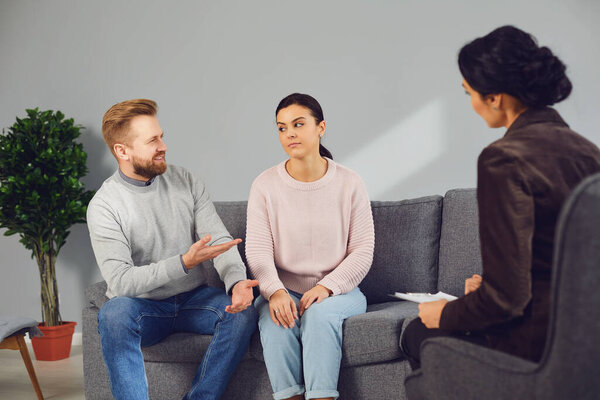 Family psychologist. Female psychologist at a psychotherapy session with family in the office.