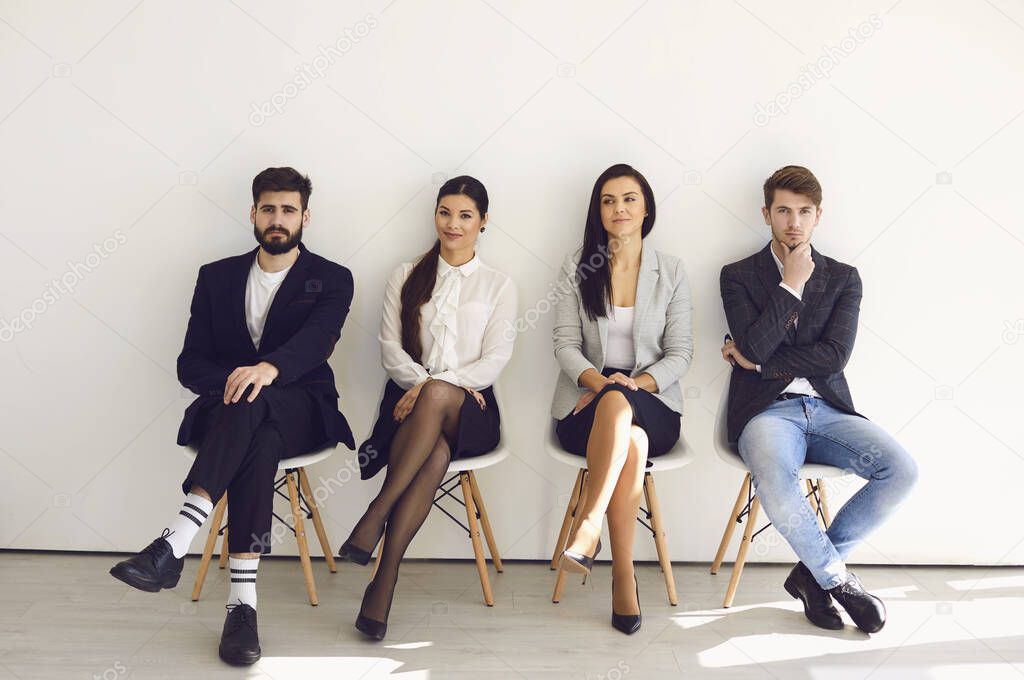 Business people waiting for job interview recruitment sitting on a chair in the office.