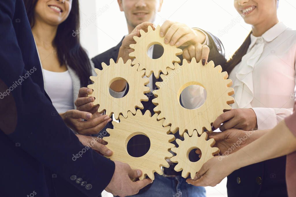 Group of businessmen with gears at the table at the workplace in the office.