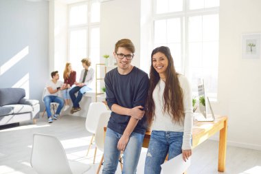 Teamwork. Students prepare a job analyze discuss business strategies at a table in the office.