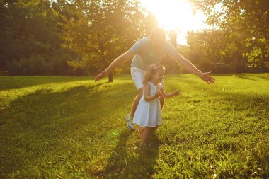 Fathers day. Father plays with his daughter in the summer park.