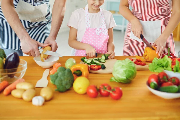 Family cooks fresh vegetables on the table in the kitchen. — Stock Photo, Image