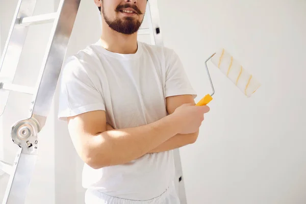 House painter in white uniform on a white background for painting in the room.