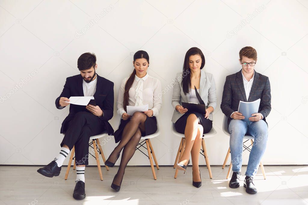 Business people waiting for job interview recruitment sitting on a chair in the office.