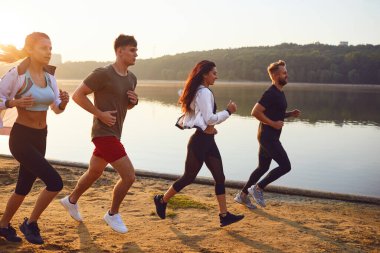 A group of young athletes are running in a park.