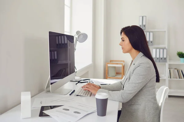 オンラインで働く。ビジネスの女性が屋内の自宅でコンピュータに座っている. — ストック写真