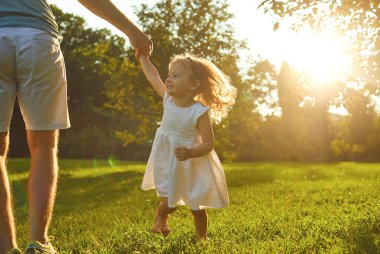 Fathers day. Father plays with his daughter in the summer park.