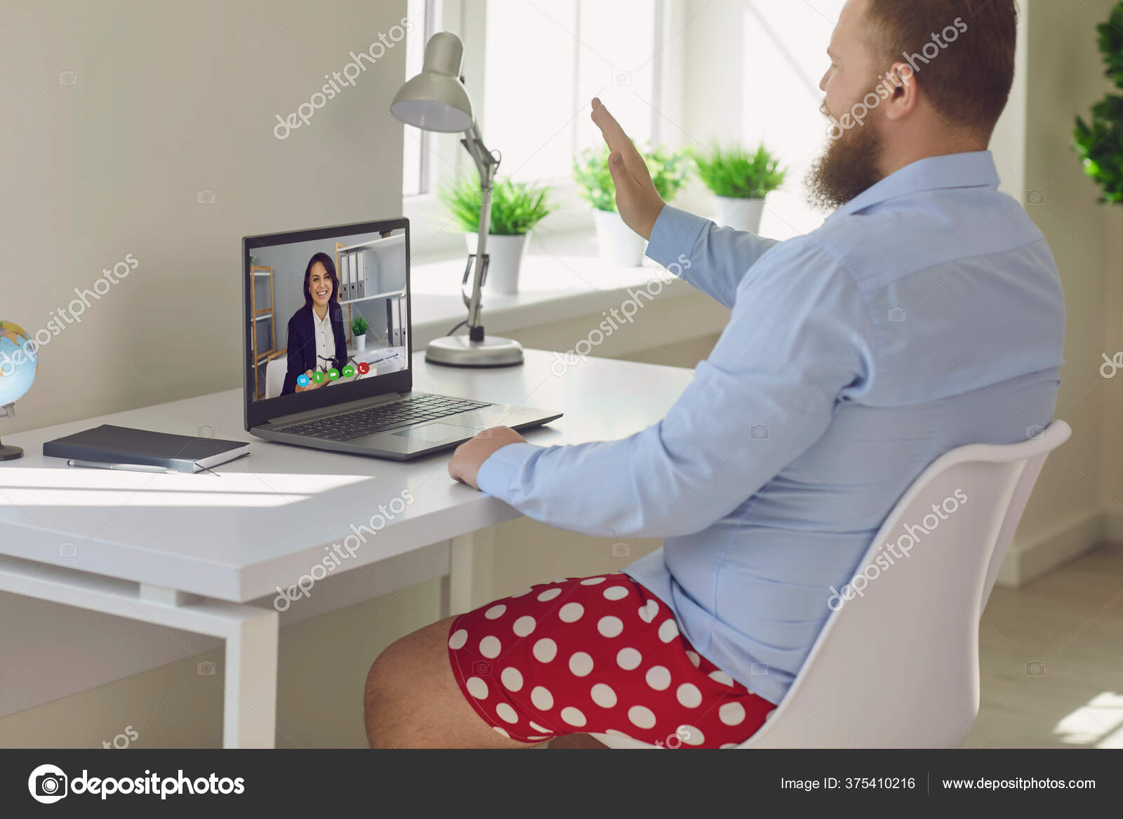 Online work at home. Funny fat businessman in red shorts works ...